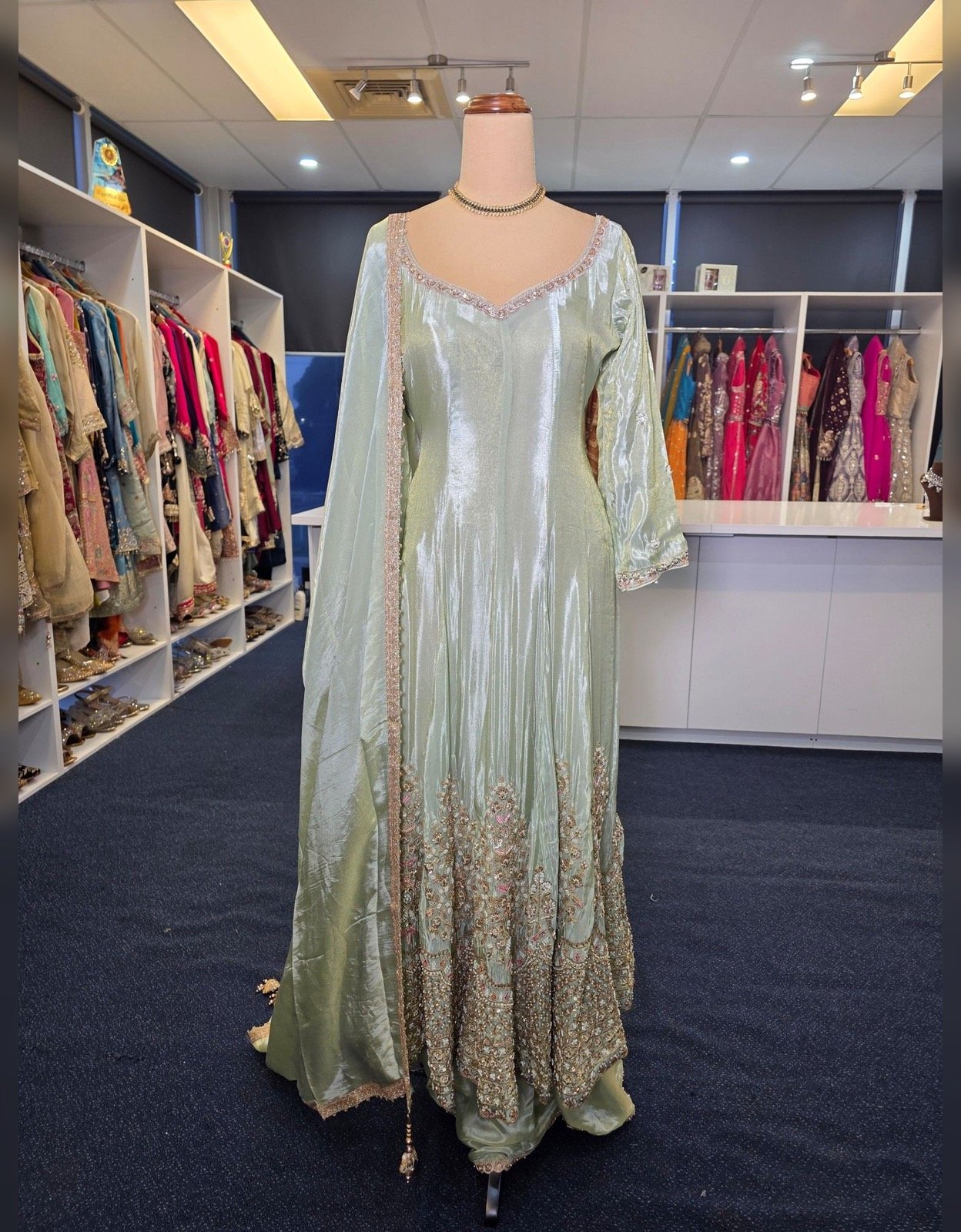 Mint green embroidered gharara suit with silver floral border embroidery and matching dupatta, displayed at Raunak Boutique Epping