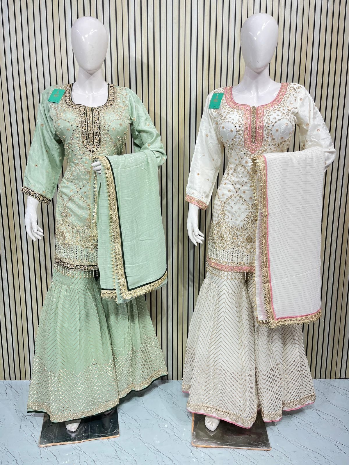 Mint green and white embroidered sharara suits with matching dupattas displayed at Raunak Boutique