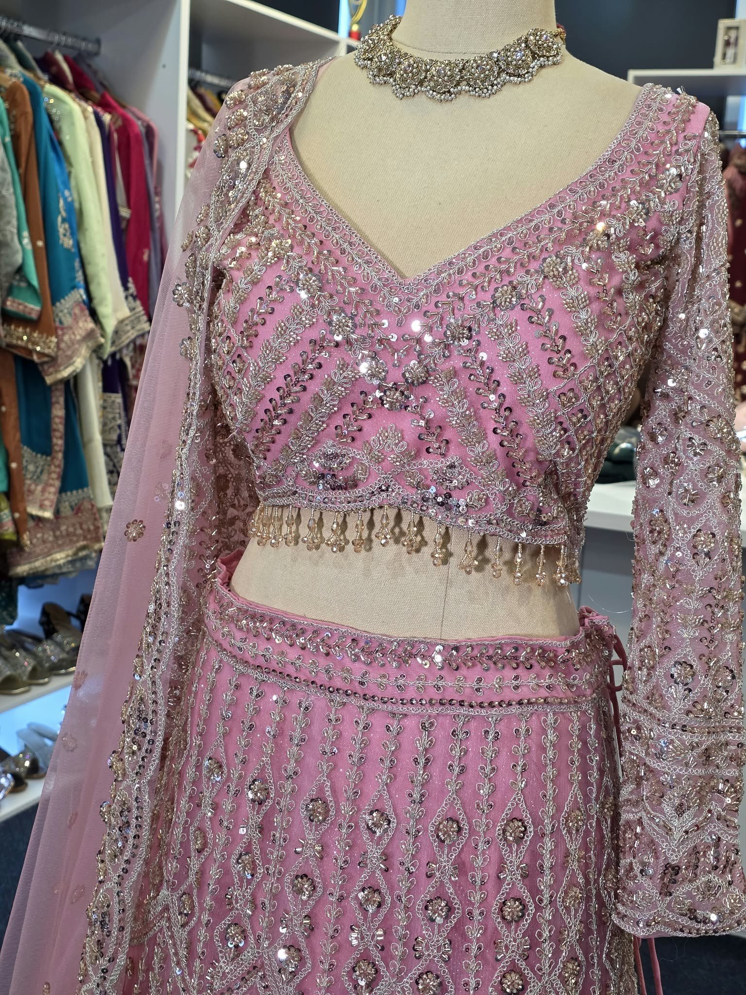 Close-up detail of pink and silver embroidery on the designer lehenga