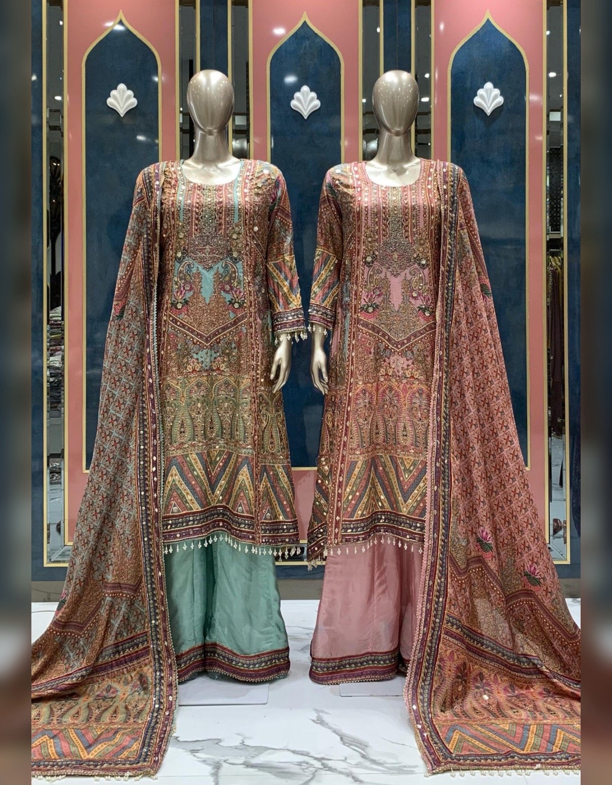 Mint green and blush pink printed sharara suits with matching dupattas displayed at Raunak Boutique Epping