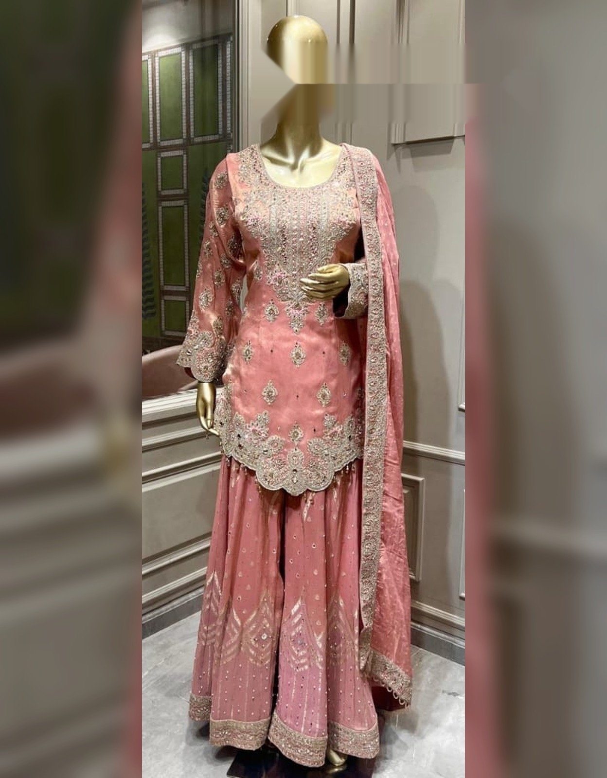 Rose pink embroidered gharara suit with ornate silver embroidery and matching dupatta, displayed on a mannequin
