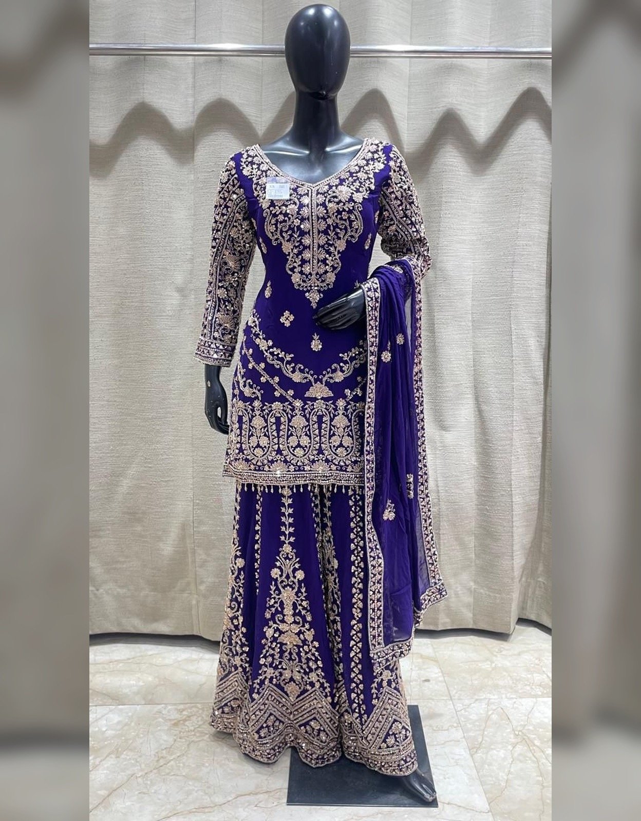 Royal purple embroidered sharara suit with intricate gold embroidery and matching dupatta at Raunak Boutique